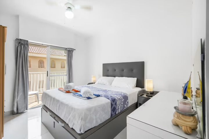 Master bedroom with king bed and balcony