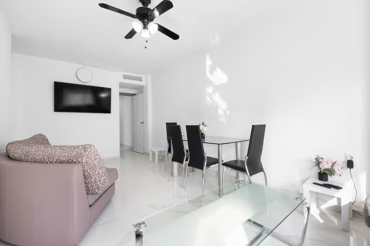 Bright open-plan living, dining and balcony at Torri Apartments
